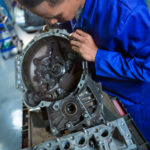 Mechanic repairing engine part at the repair garage